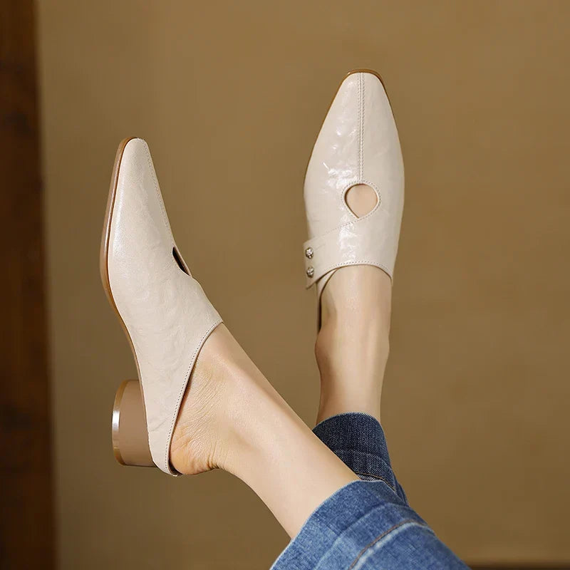 Light beige leather mules with pointed toe and round side cutout