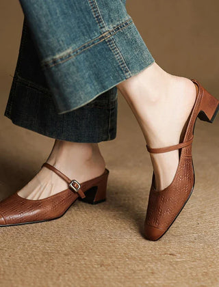 Brown leather mules with ankle strap and low block heel worn with cuffed jeans