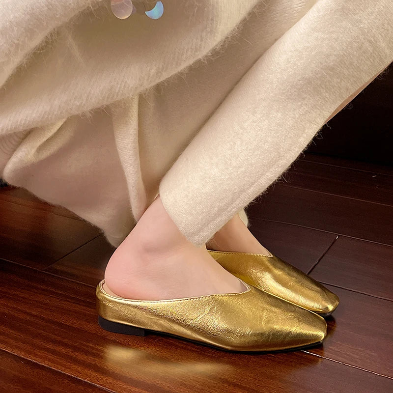 Gold slip-on mules with pointed toe and low block heel, metallic finish