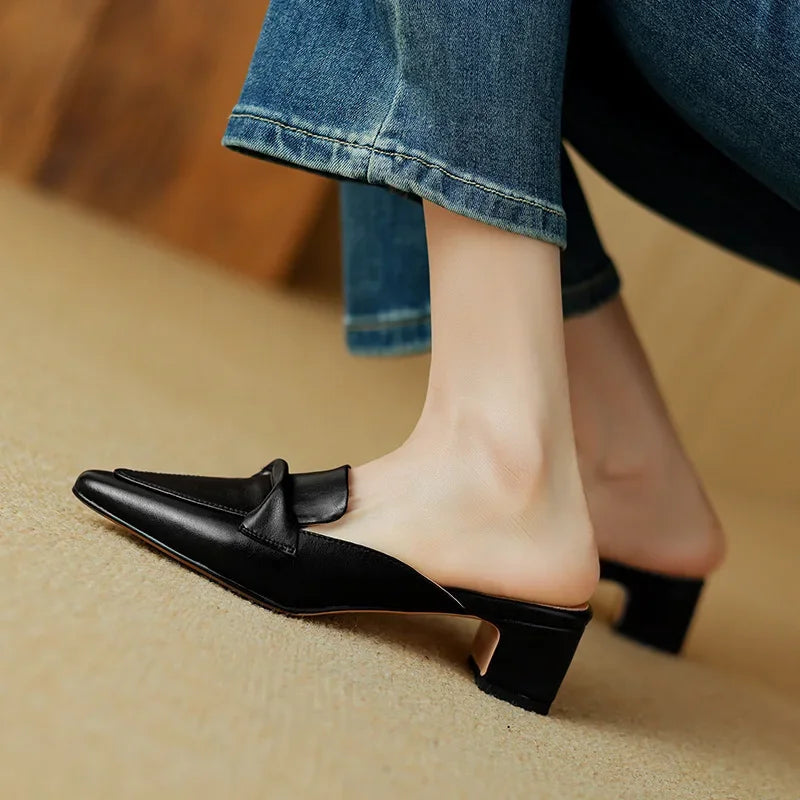 Black genuine leather mule with low block heel and smooth slip-on design