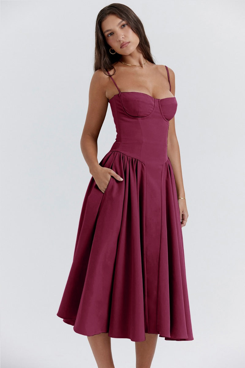 Burgundy corset sundress with thin straps and a pleated A-line midi skirt