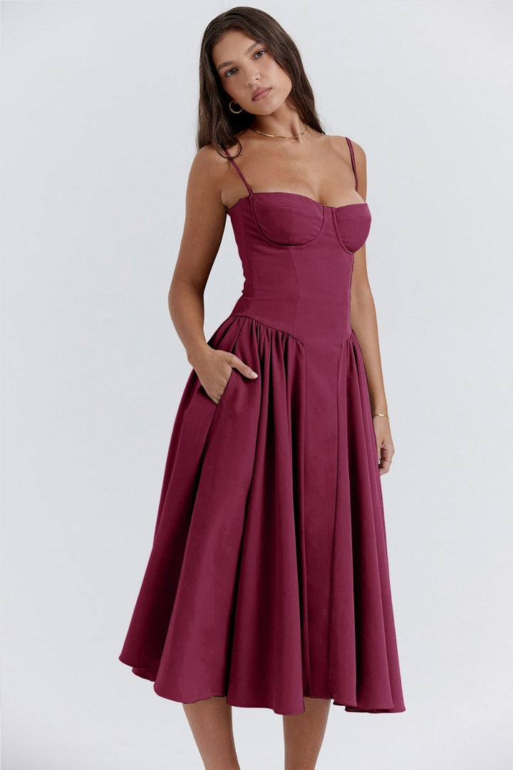 Burgundy corset sundress with thin straps and a pleated A-line midi skirt