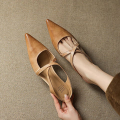 Tan leather mules with pointed toe and slingback strap, low heel.