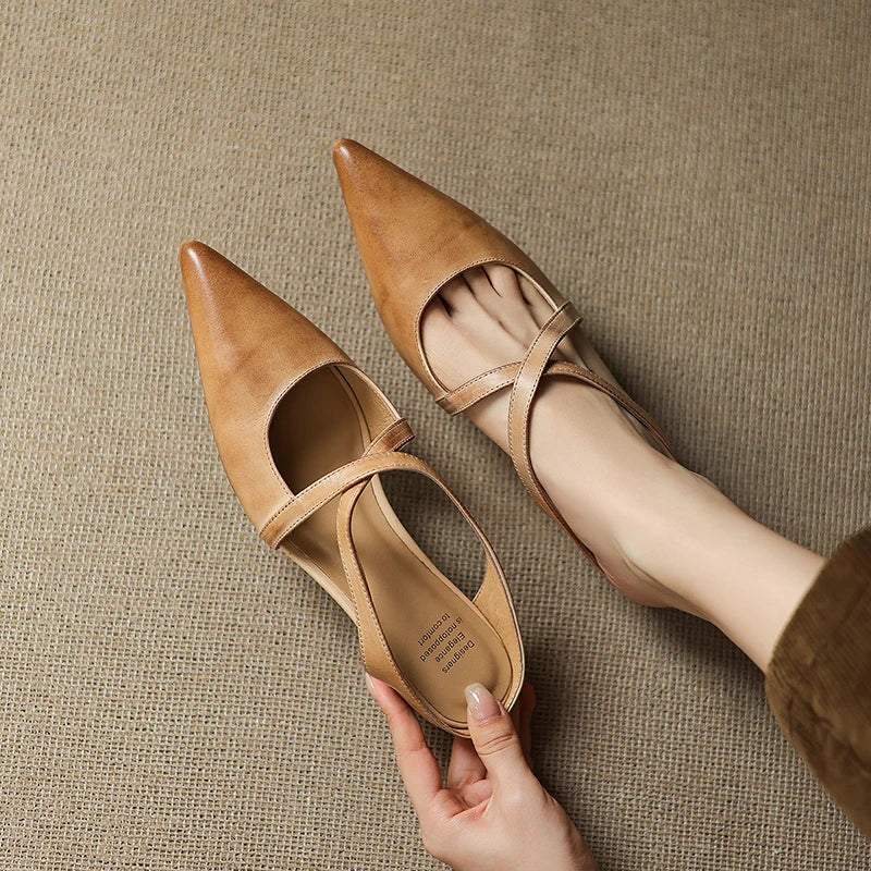 Tan leather mules with pointed toe and slingback strap, low heel.