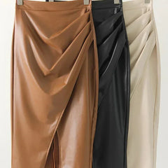 Set of three leather midi skirts on hangers: tan, black, and cream