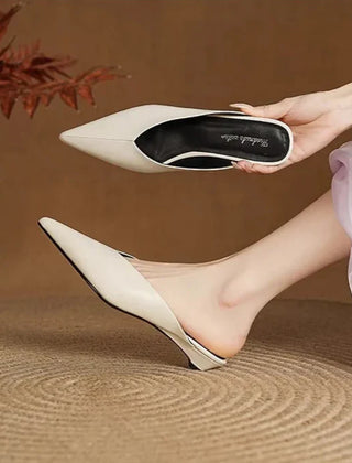 Beige leather mules held up, pointed toe and low heel slip-on