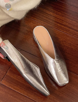 Silver metallic mules with pointed toe and low block heel, slip-on style
