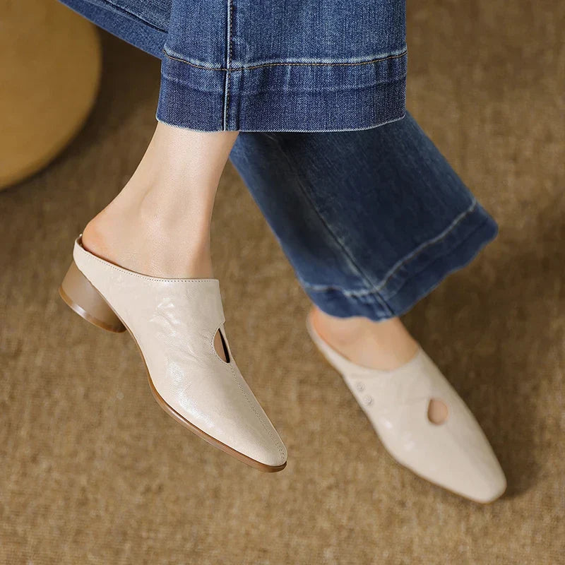Beige leather mules with pointed toe and side cutout, low heel