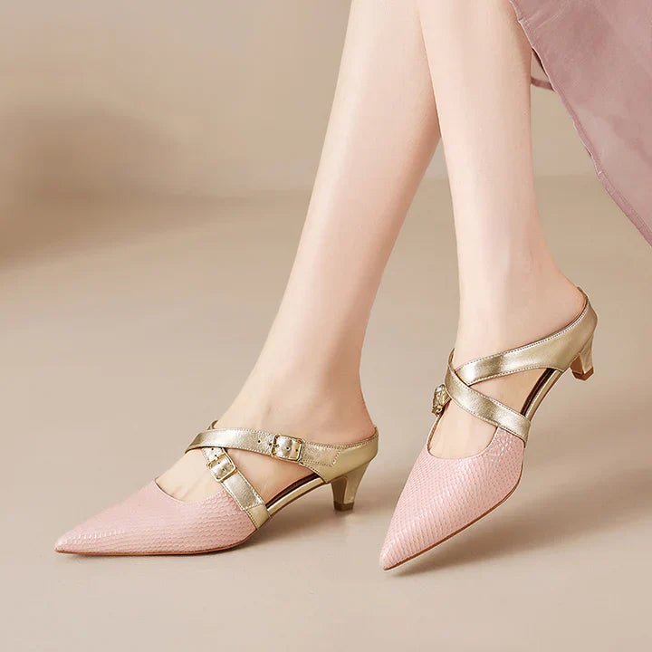 Pink textured leather mules with gold buckled ankle straps and a short block heel.