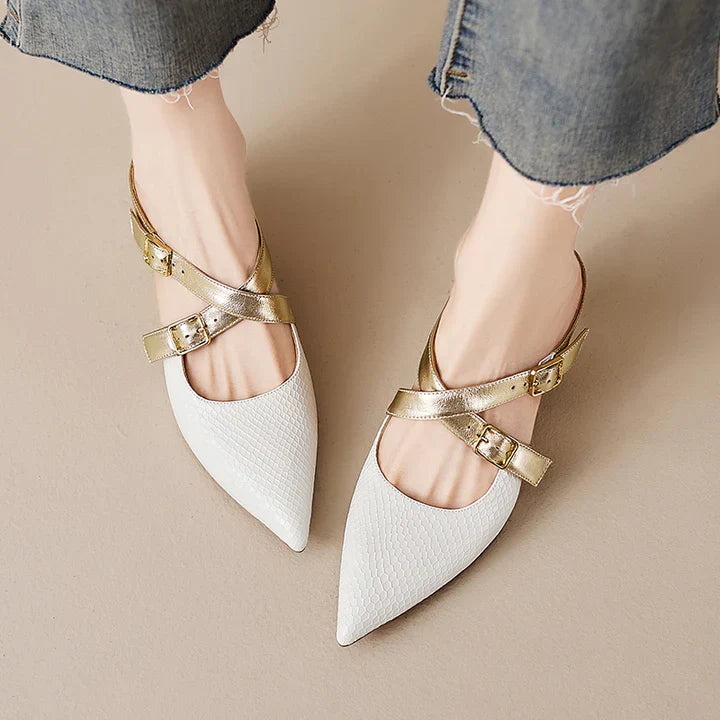 Pair of white genuine leather mules with gold-tone buckle straps and pointed toe