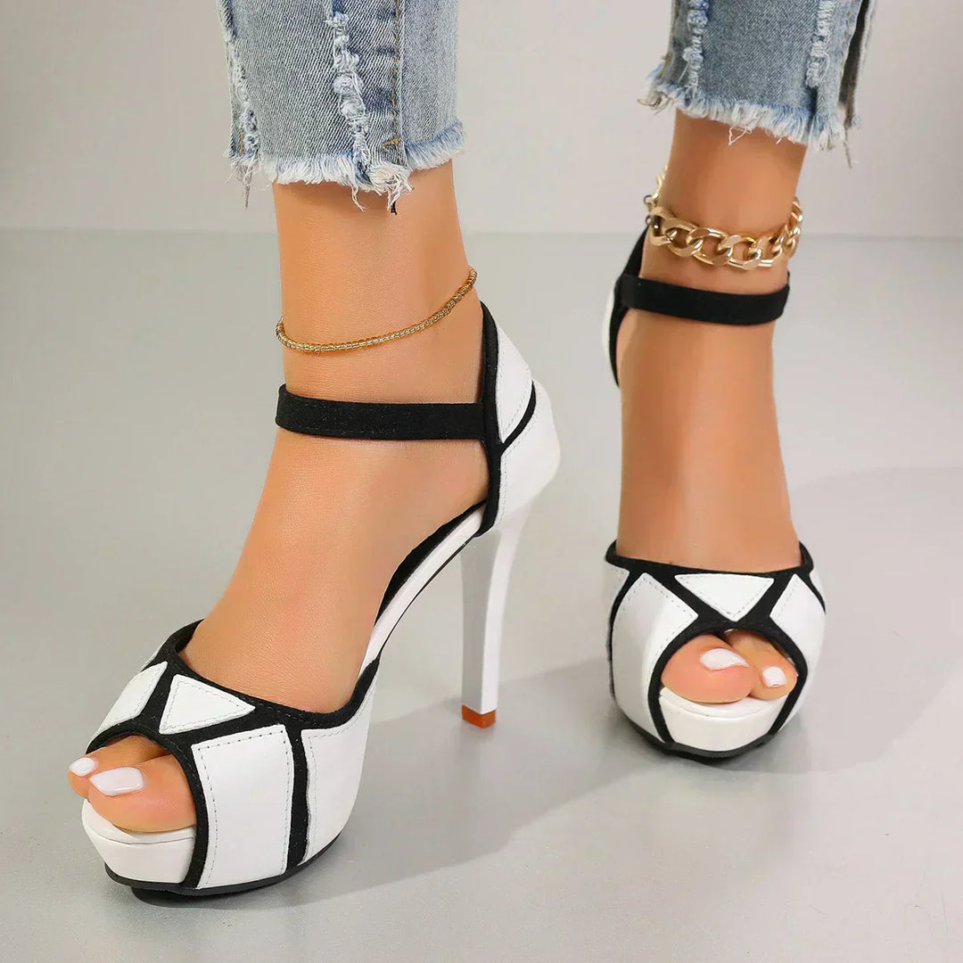 White-and-black heeled sandals with open toe, ankle strap, and stiletto heel