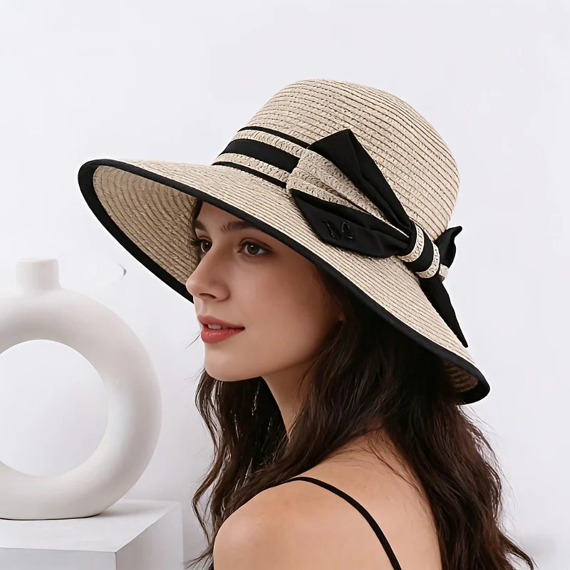 Beige wide brim sun hat with black ribbon band and bow detail