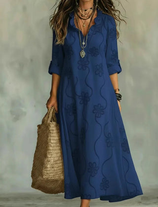 Blue maxi dress with short sleeves and subtle floral pattern, V-neck.