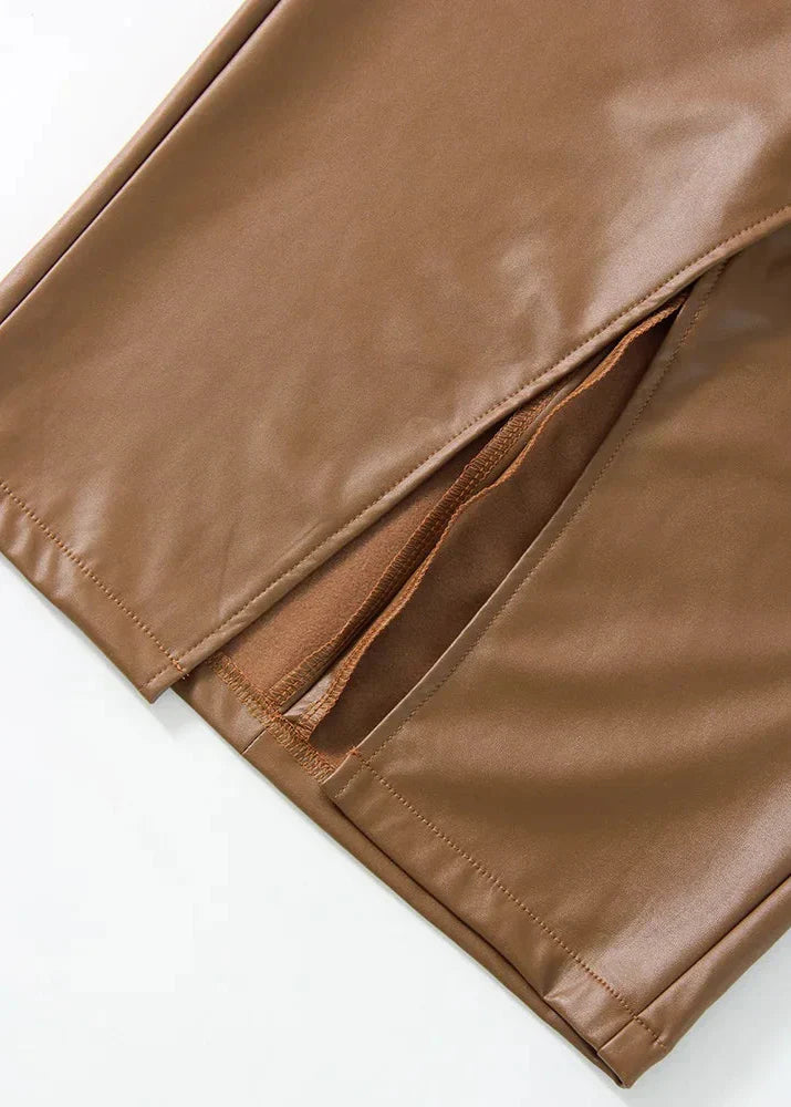 Close-up of brown leather skirt hem with stitching and narrow side slit