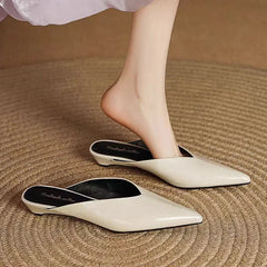 Cream leather mules with pointed toe and low heel, showing inner lining