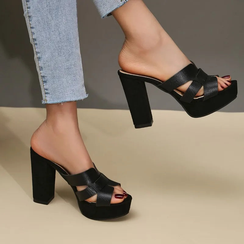 Black platform heeled sandals with cross straps and mid-height block heel