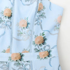 Close-up of light blue floral fabric with stitched seam lines