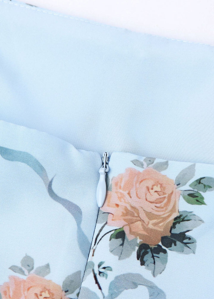 Close-up of light blue floral lining with ruched seam and zipper