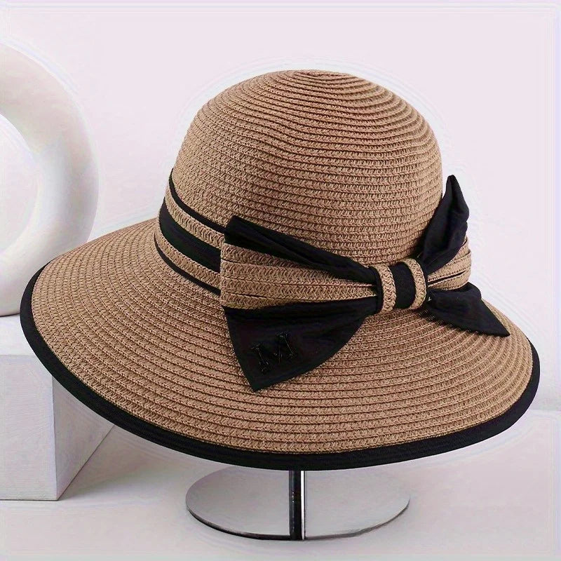 Brown wide brim sun hat with black ribbon band and bow