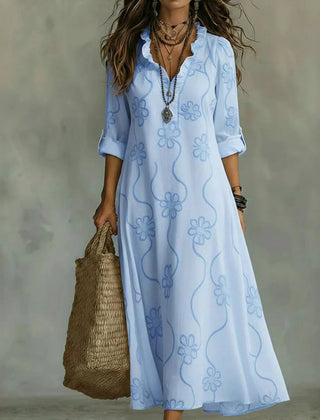 Light blue maxi dress with short sleeves and subtle floral pattern, V-neck.