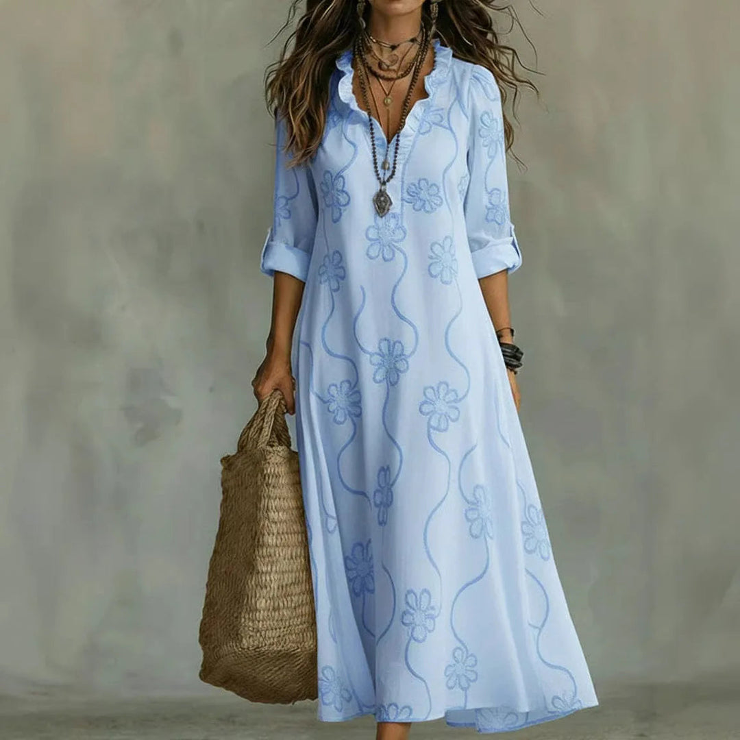 Light blue maxi dress with short sleeves and subtle floral pattern, V-neck.