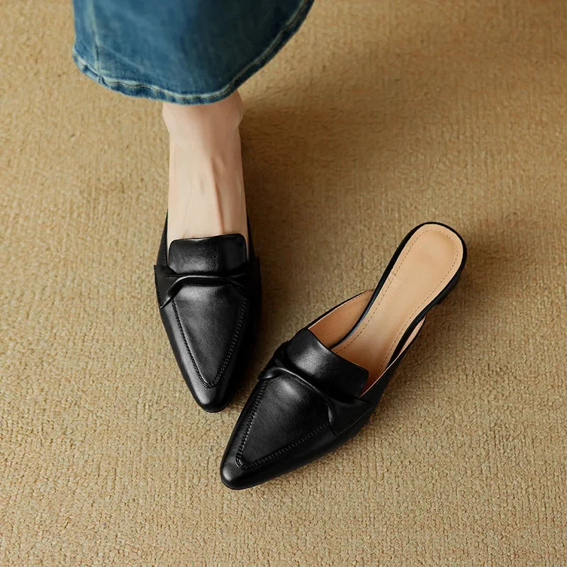 Black genuine leather mules with low heel and tan insole lining, slip-on loafer shape