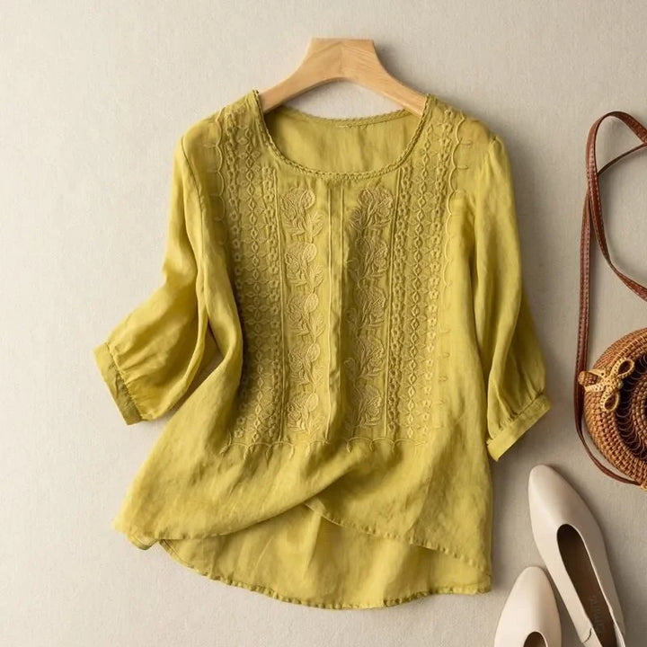 Yellow elegant soft blouse with round neck, textured embroidered front, three-quarter sleeves
