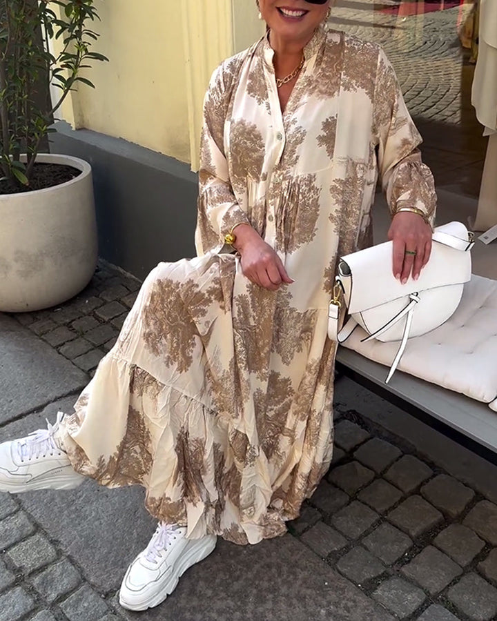 Beige tiered maxi dress with brown abstract print, button-front, and long sleeves.
