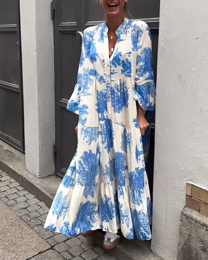 Flowing long blue-and-white printed dress with V-neck, button front, tiered skirt