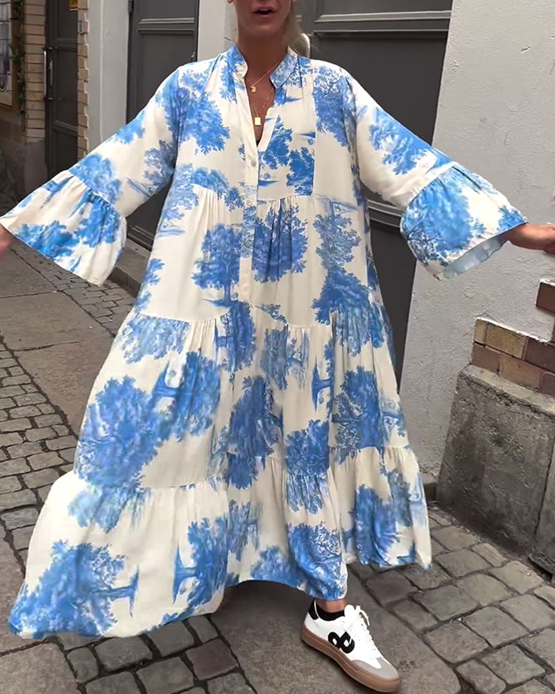 Flowing long blue-and-white printed dress with V-neck, button front, flared sleeves