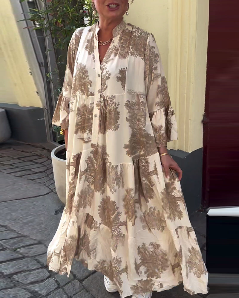 Light beige long-sleeve maxi dress with brown abstract pattern and button-front V neckline.