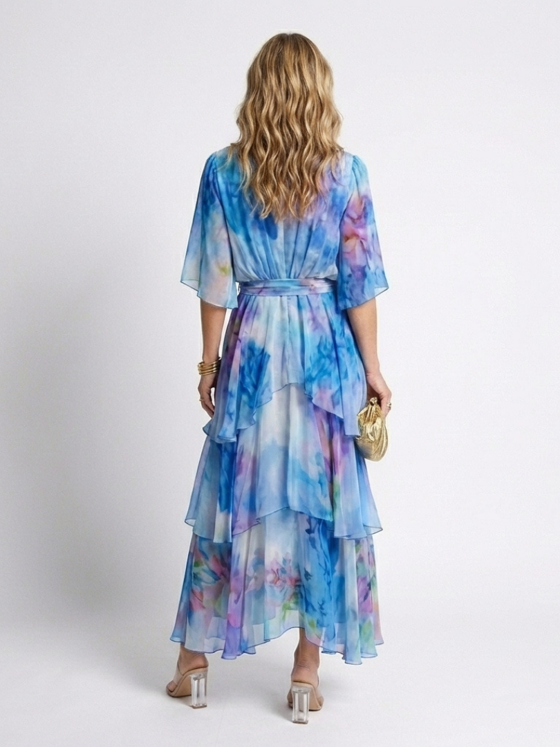 Blue tie-dye sheer tiered maxi dress with V-neck and tie waist, back view