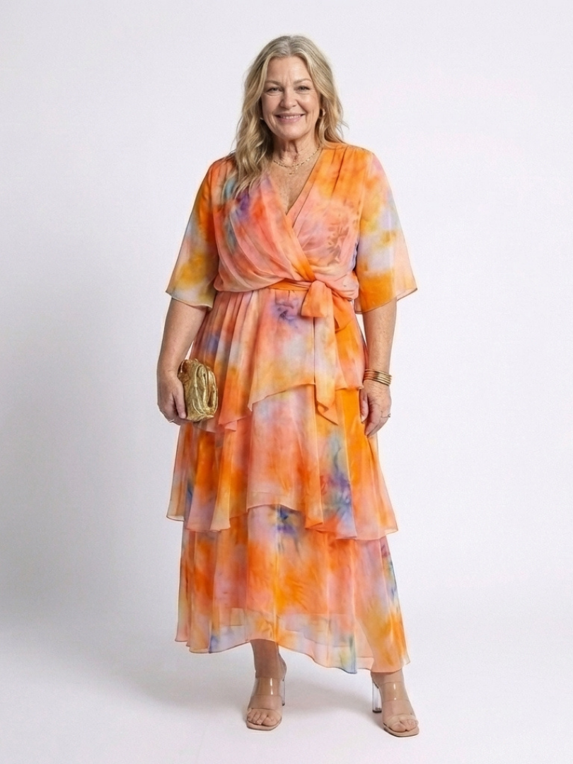 Orange sheer tiered maxi dress with V-neck and tie waist, layered ruffle hem