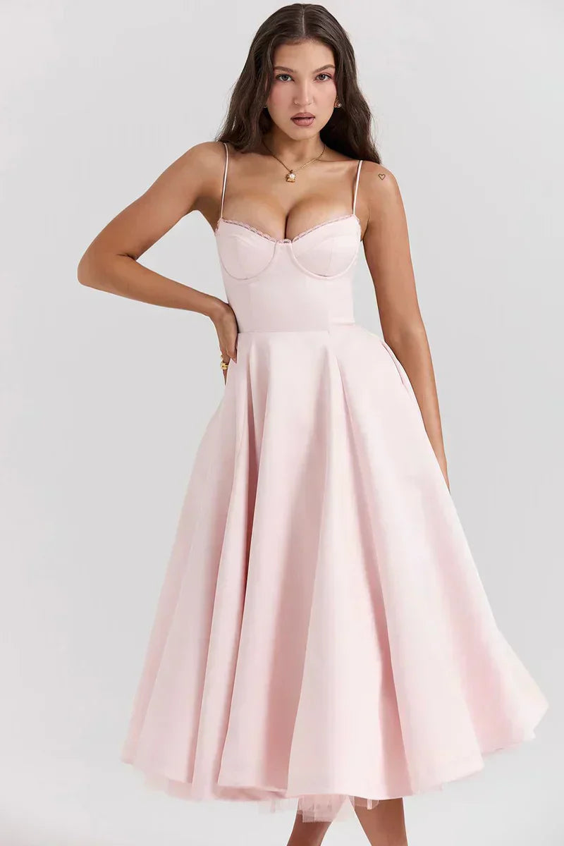 Blush pink sweetheart dress with thin straps, fitted bodice, and flared skirt