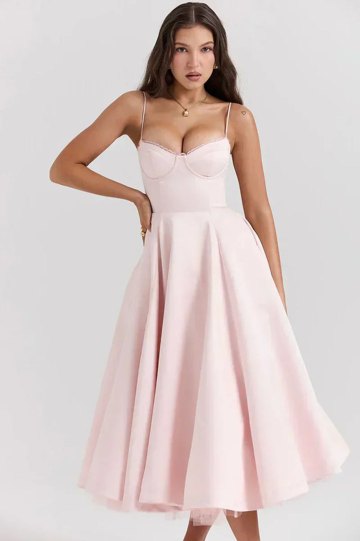 Blush pink sweetheart dress with thin straps, fitted bodice, and flared skirt