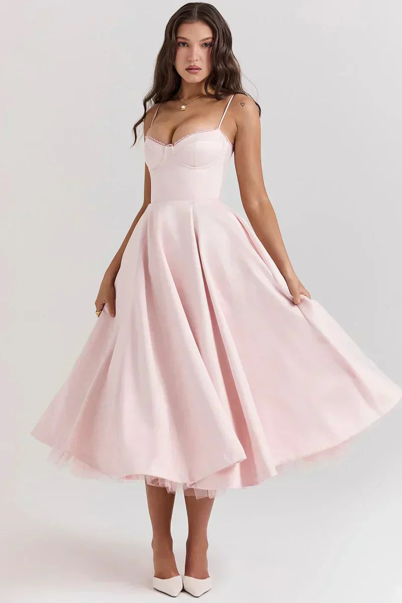 Blush pink fit-and-flare dress with spaghetti straps, sweetheart bodice, and flared skirt.