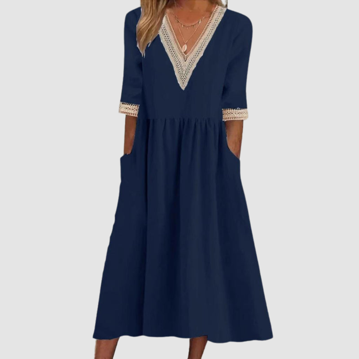 Navy mid-length dress with V-neck embroidered trim, 3/4 sleeves, and tiered skirt