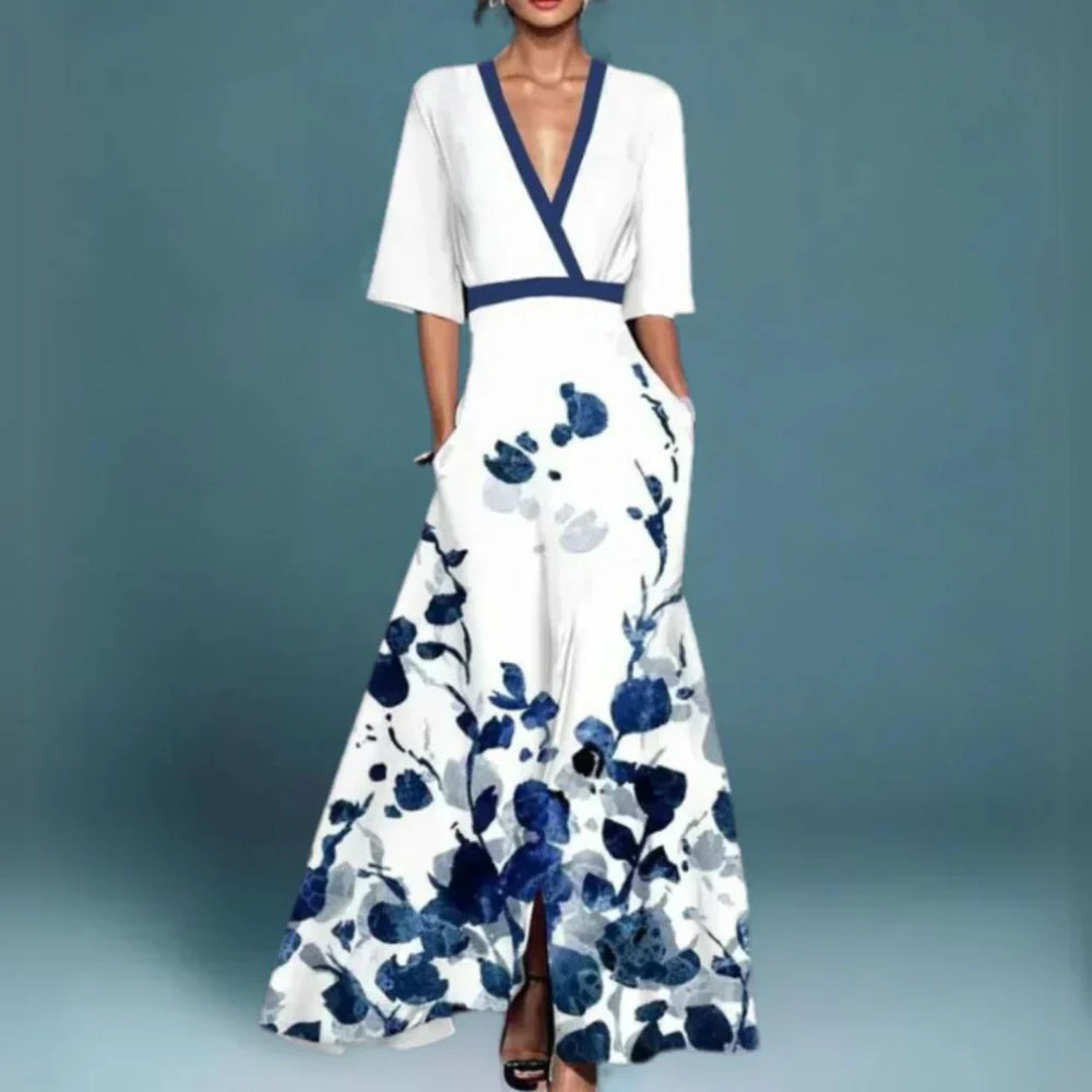 White maxi dress with V-neck and navy floral print, short sleeves, tiered skirt