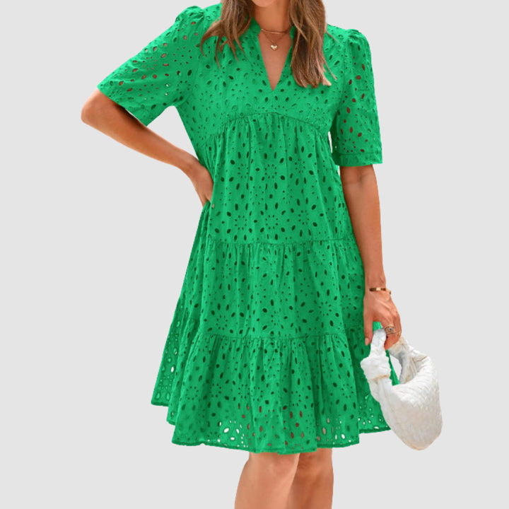 Bright green V-neck tiered babydoll summer dress, short sleeves, dotted pattern.