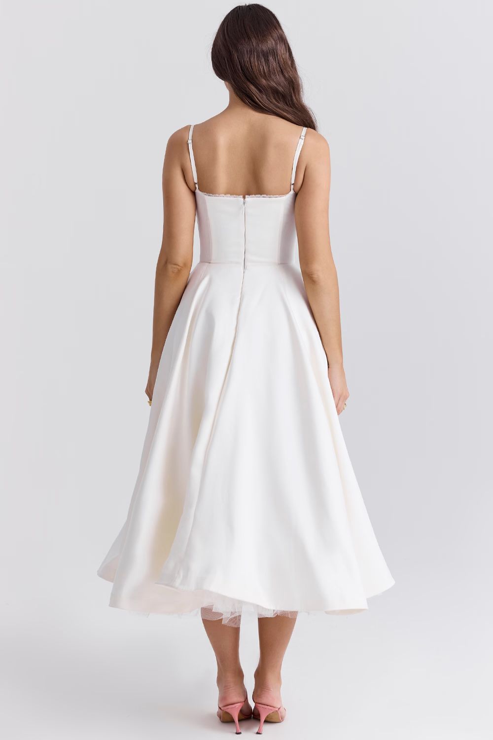 White backless-style midi dress with thin straps and full gathered skirt
