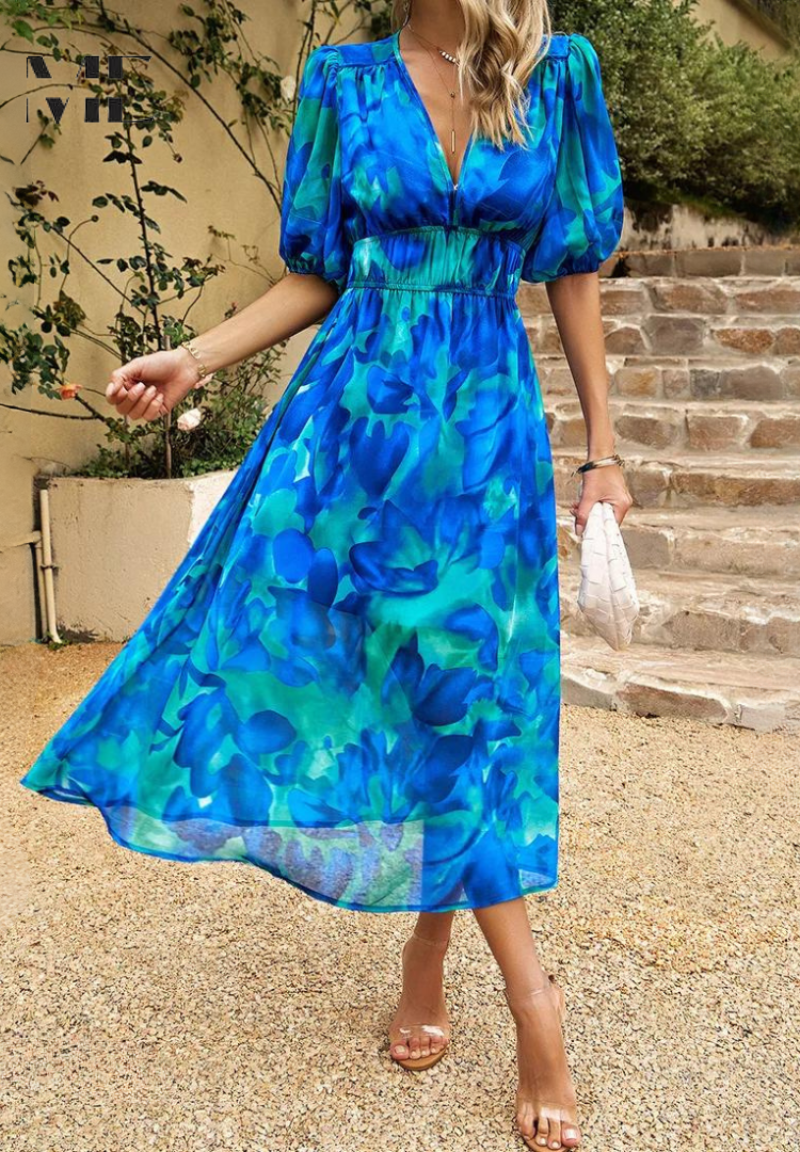 Blue midi dress with V-neck and short puff sleeves; flowing skirt and gathered waist