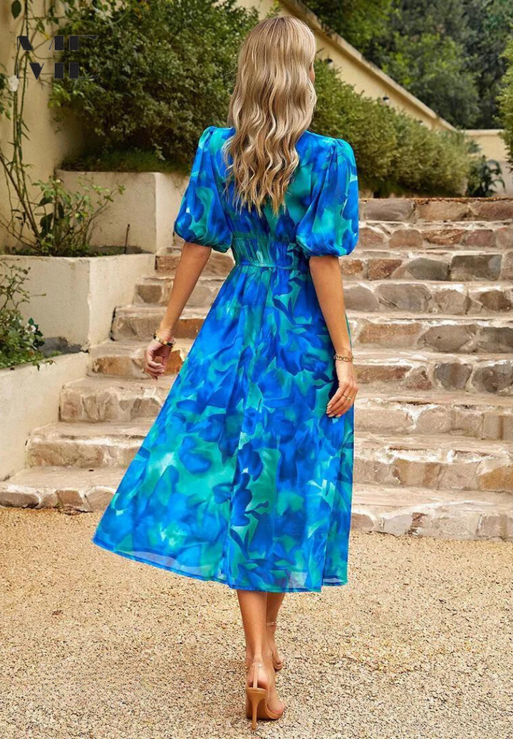 Blue midi dress with puff sleeves and gathered waist; back view on a staircase setting