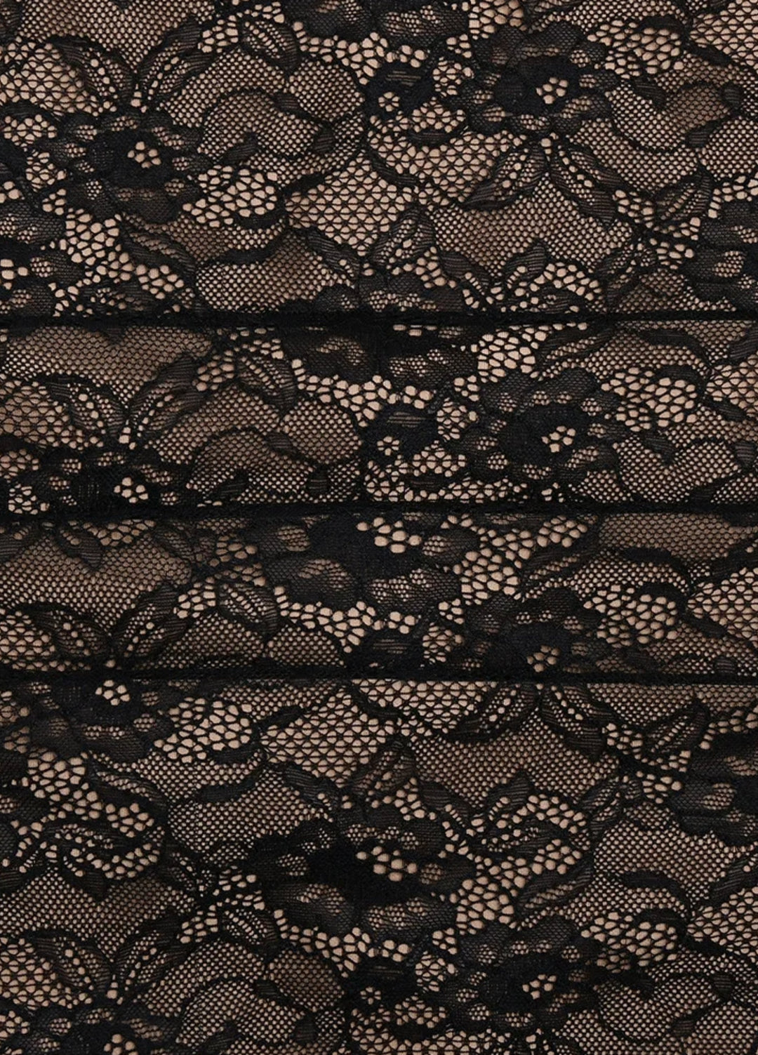 Black lace fabric close-up with intricate floral pattern for the maxi dress