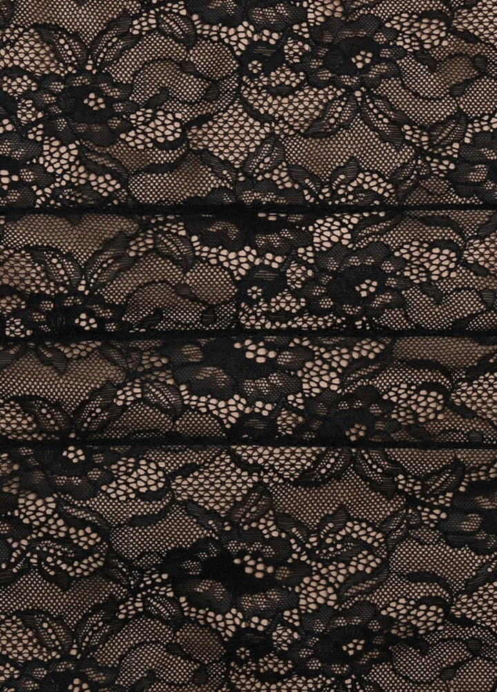 Black lace fabric close-up with intricate floral pattern for the maxi dress