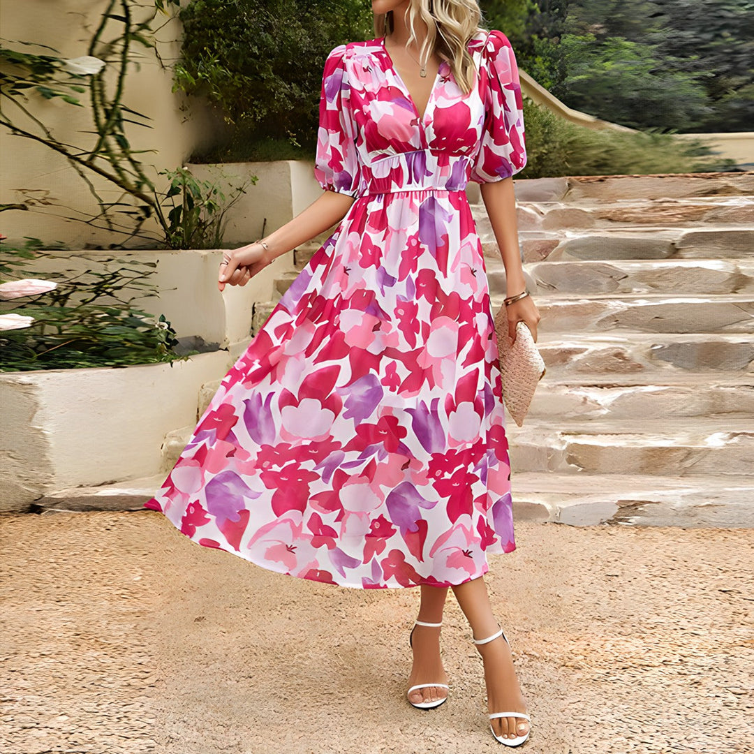 Pink and white V-neck midi dress with puff sleeves and gathered waist, floral pattern.