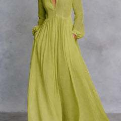 Green long-sleeve maxi dress with V-neck and gathered, pleated full skirt