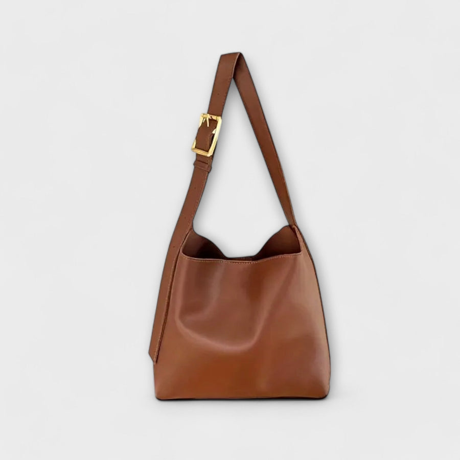 Brown leather shoulder bag with top handle and gold-tone buckle strap