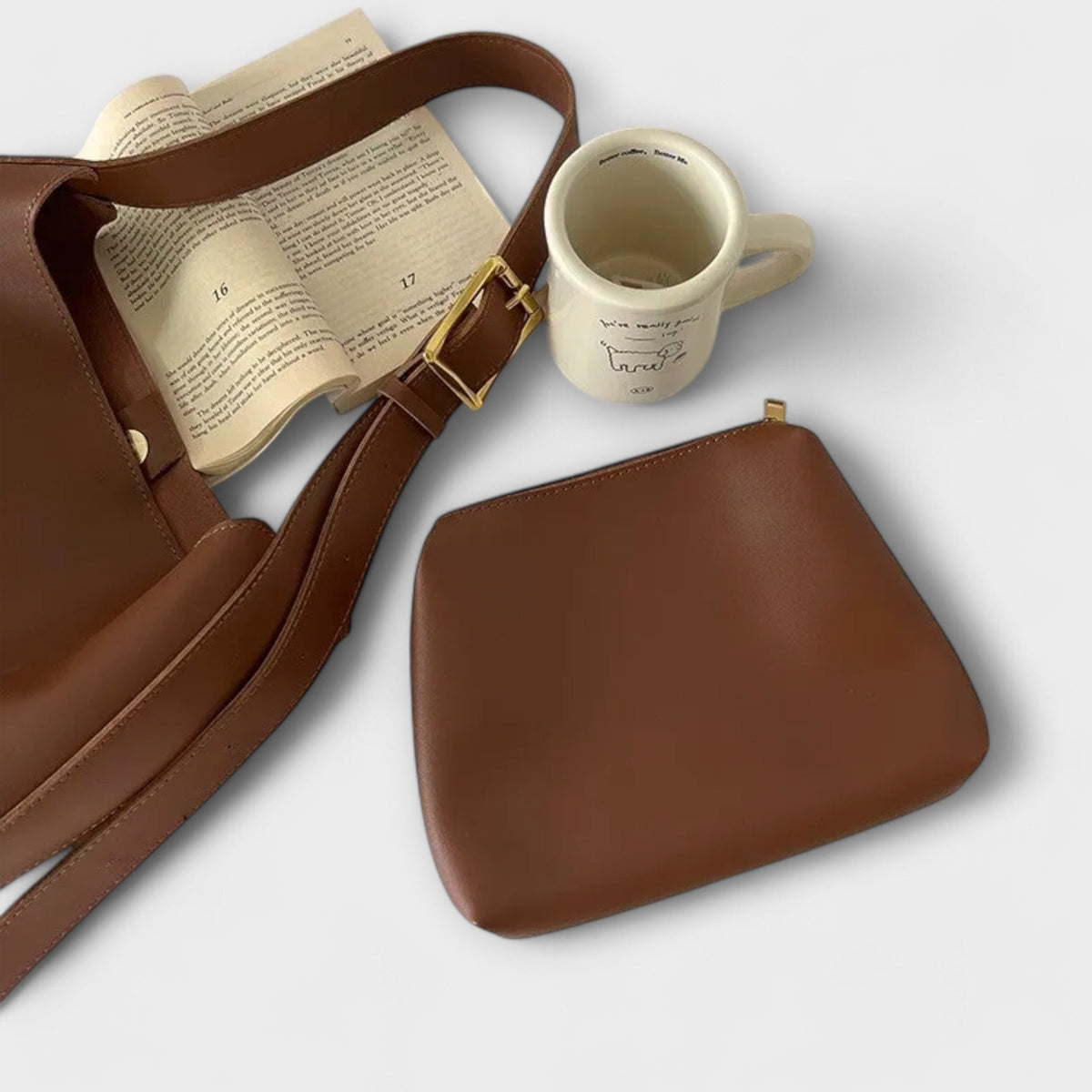 Brown leather shoulder bag with open top, showing interior and contents