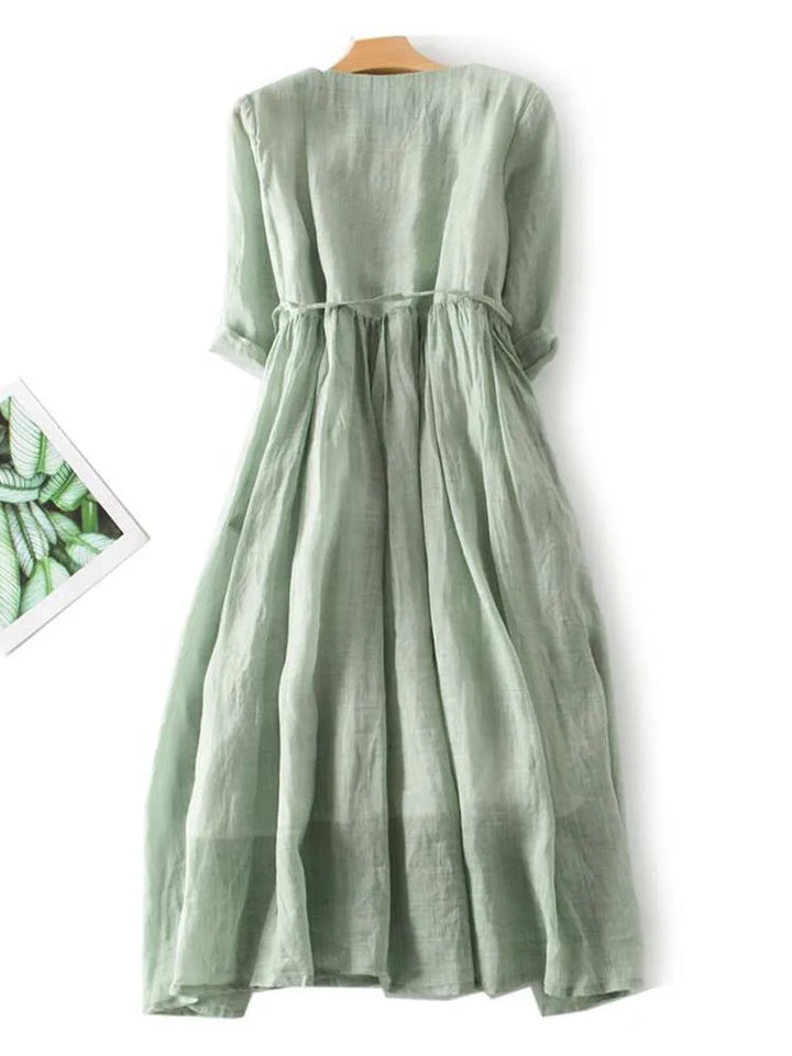 Light green linen dress back with gathered yoke and waist tie, short sleeves