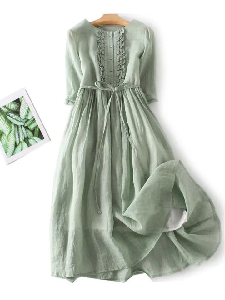 Light green linen dress back with pleated skirt and waist tie, short sleeves